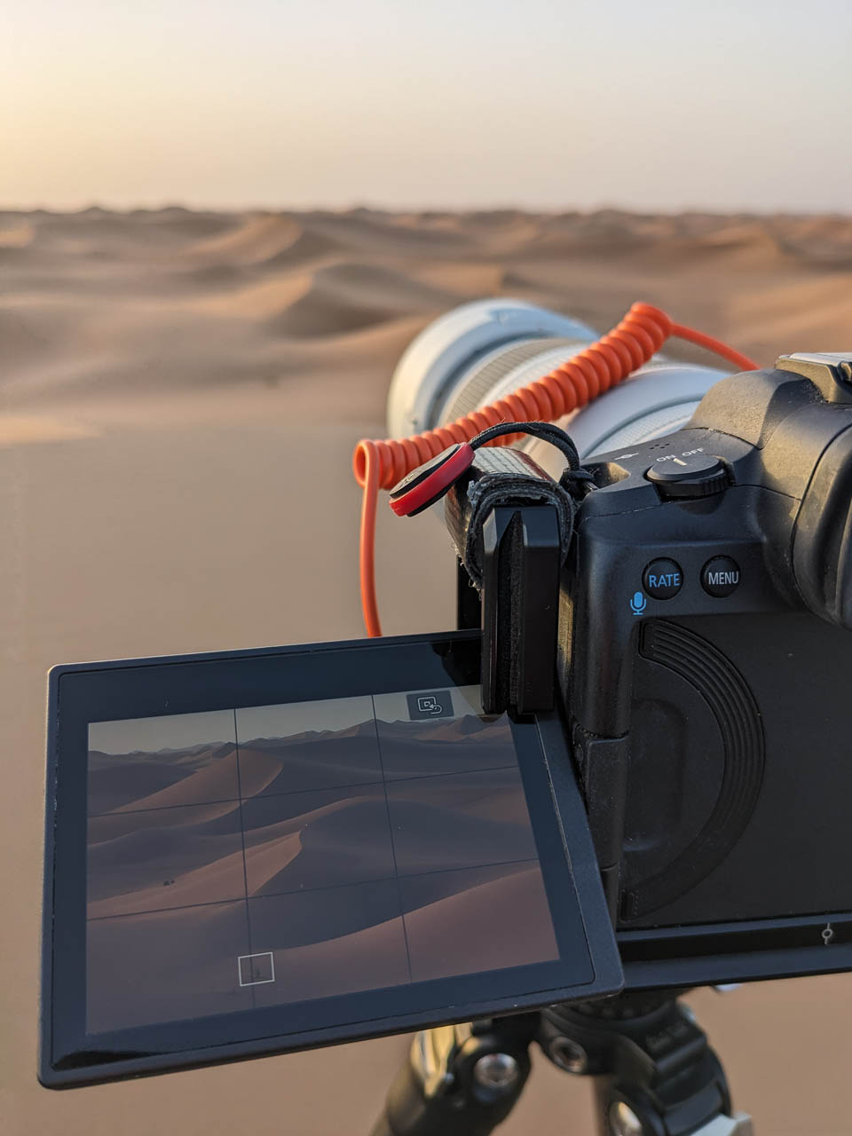 Close-up of camera display of one of participants during sunrise shoot in Desert.