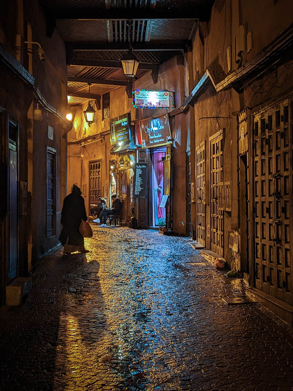 Rainy evening in marrakesh with person walking through the medina.