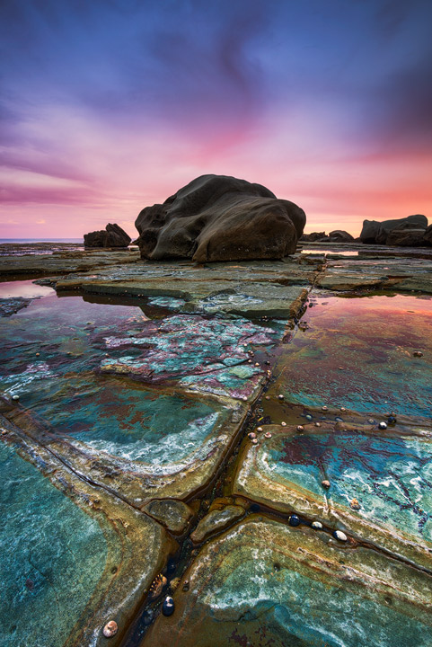 The rock structures at Forresters Beach during Sunset