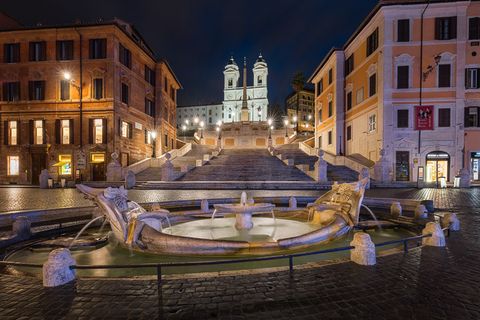The city lights illuminate the Spanish Steps