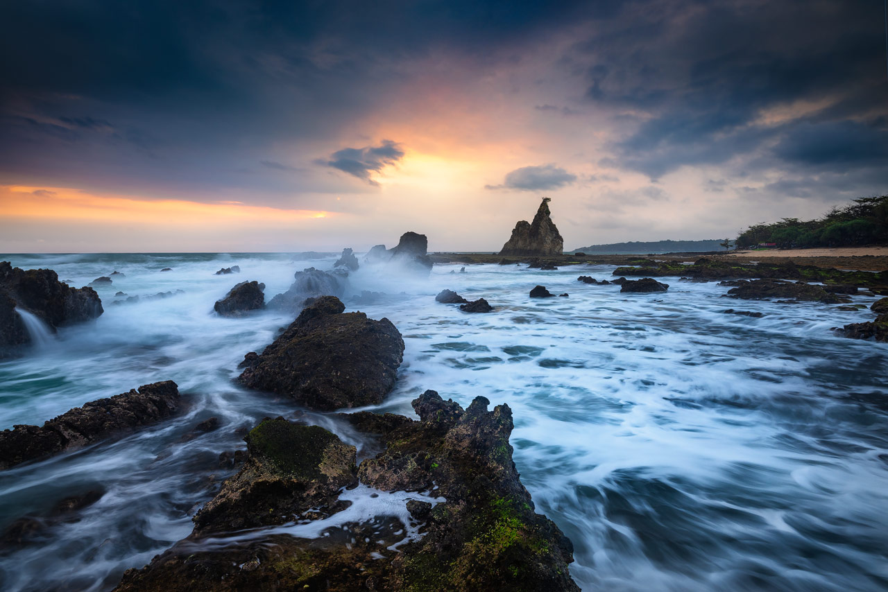 Tanjung Layar Surf Waves crashing on the rocks at Tanjung Layar near Sawarna