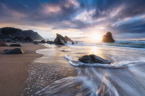 Intense sunset at the rocky Praia da Adraga beach
