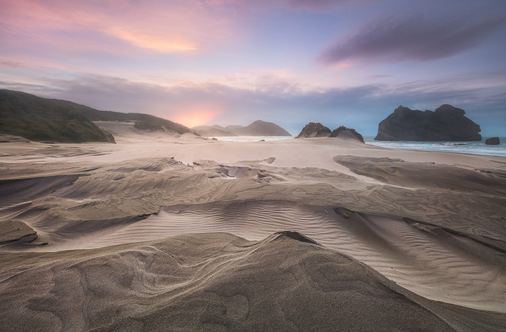 Glowing sky over the wide Wharariki Beach