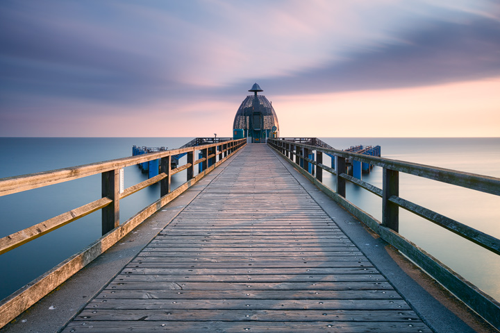 A pier leading towards a large diver's bell