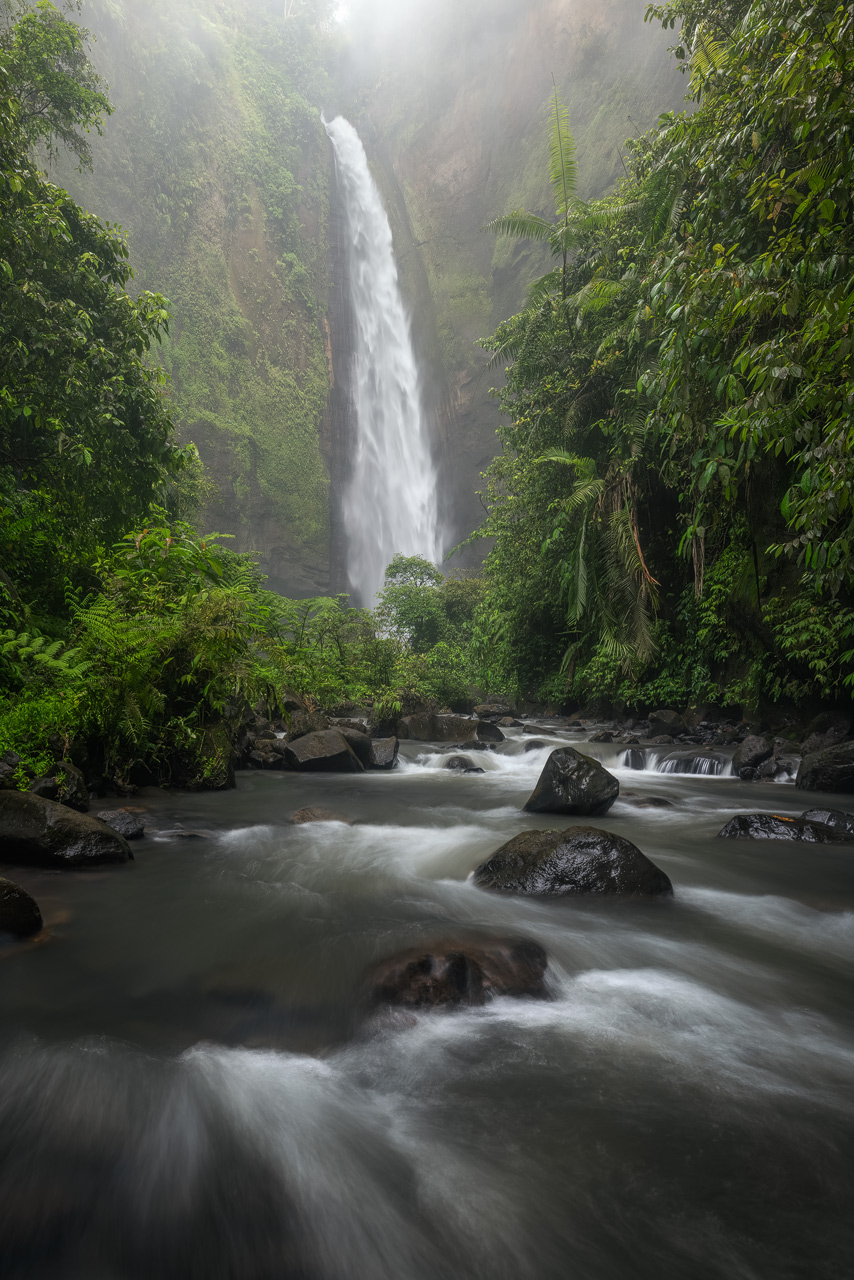 The mighty Kabut Pelangi waterfall in Indonesia on a rainy day.