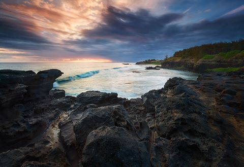 Lava Rocks, the sea and a dramatic sunset in the south of Mauritius.