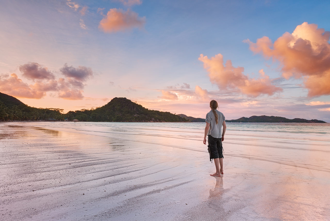 The last evening on the Seychelles. Anse Volbert were I took this photo of me is a beautiful beach lined by many palm trees. During day the beach is frequented by many people but in the evening only few remain to witness the display of light during sunset.