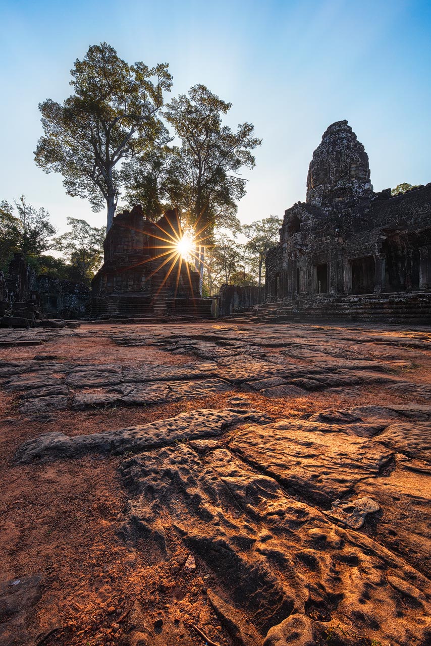 The sun lights up the Bayon temple grounds in Angkor Wat