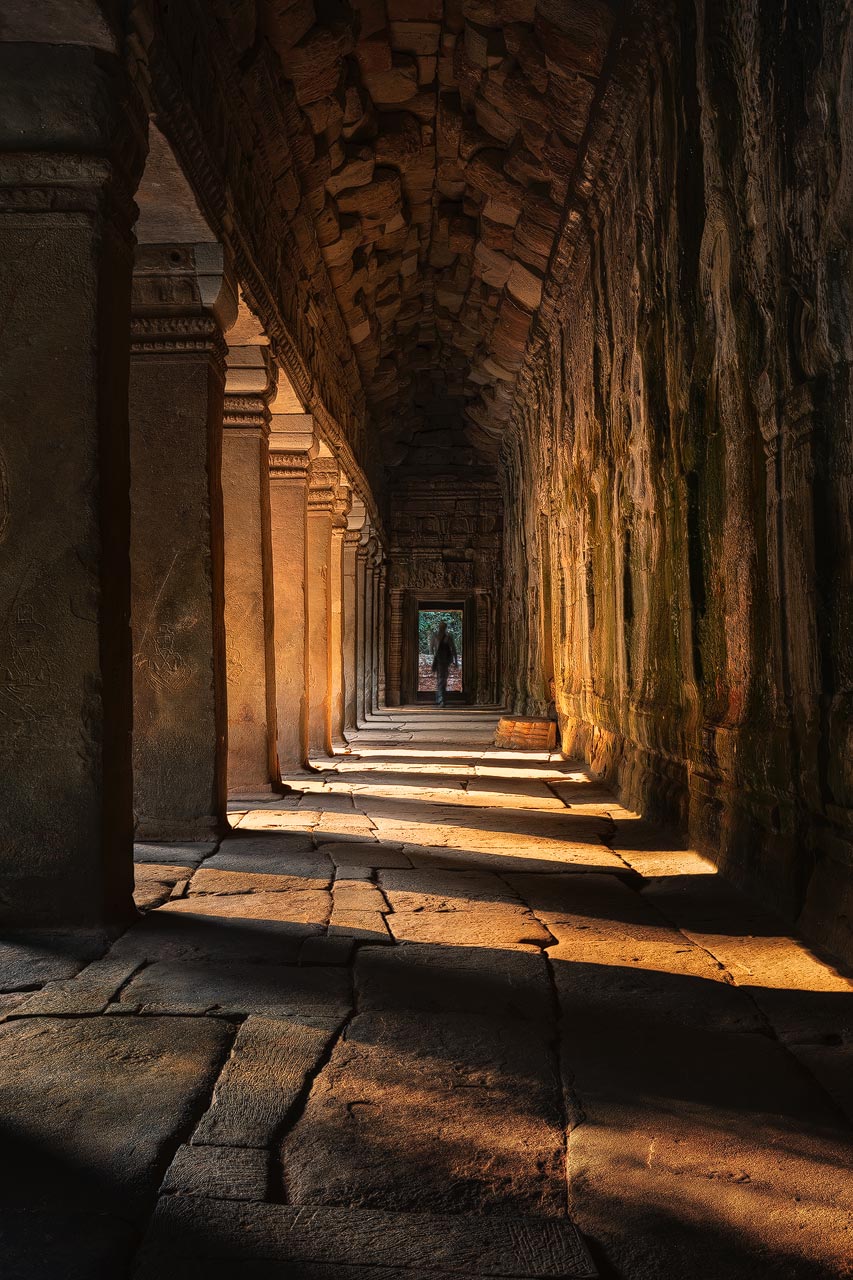 Ancient hallway in Ta Prohm illuminated by warm morning light 