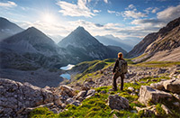A hiker in the Austrian Alps looking toward the Drachensee