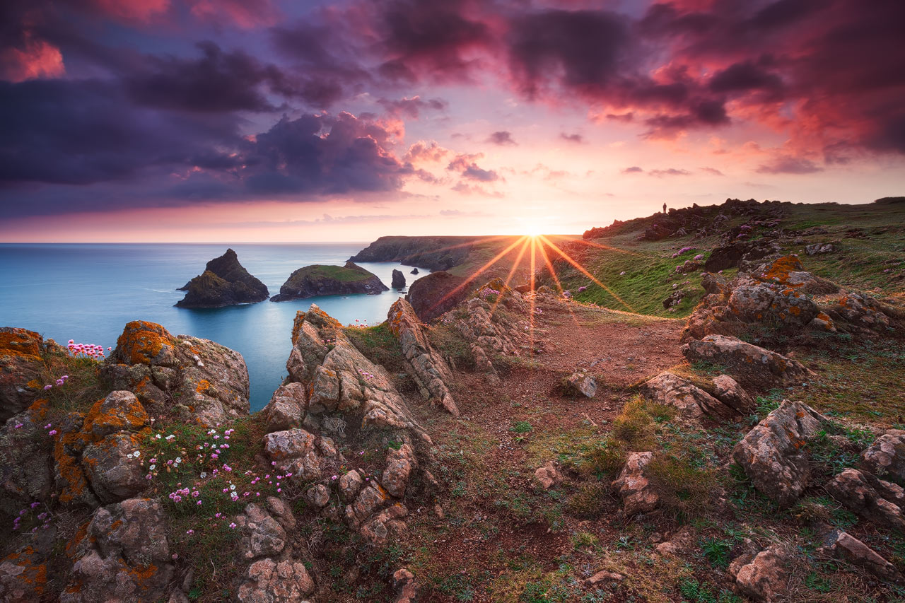 Coastal landscape at Kynance Cove in Cornwall during sunset.