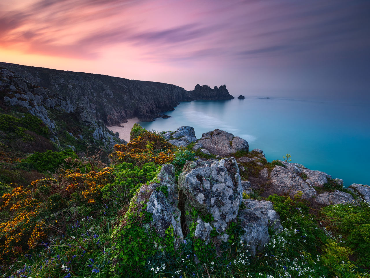 Beautiful sunrise at Pednvounder Beach with a spectacular view along the cornish cliffs.