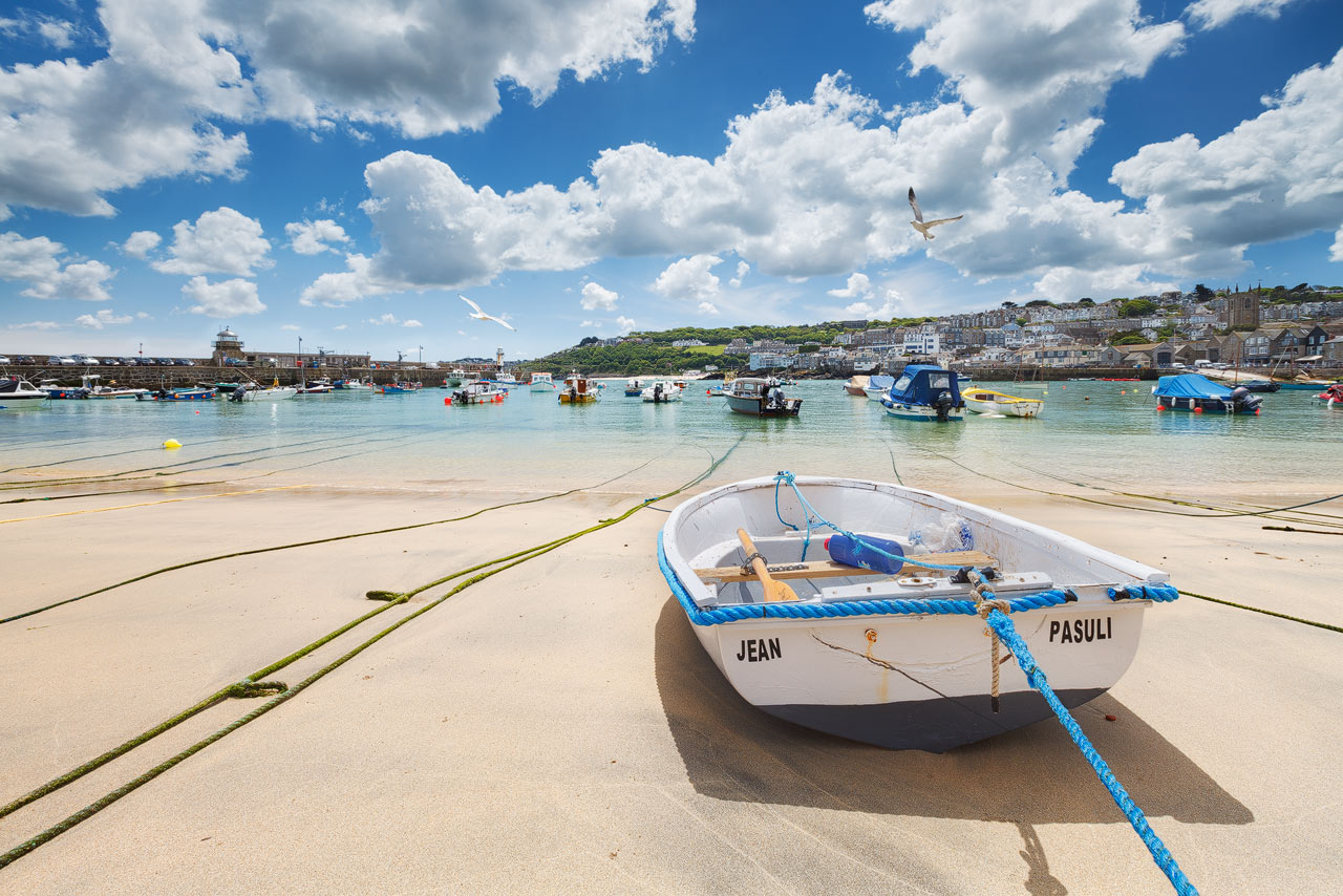 Boats in St. Ives harbour during low tide.