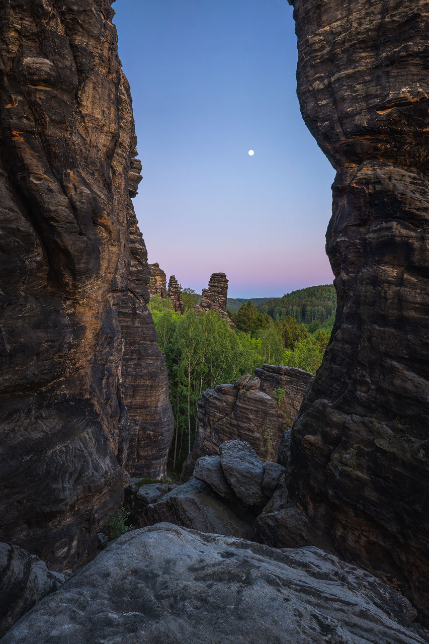 View toward the full moon through the gap between the Pillars of Hercules in Saxony Switzerland