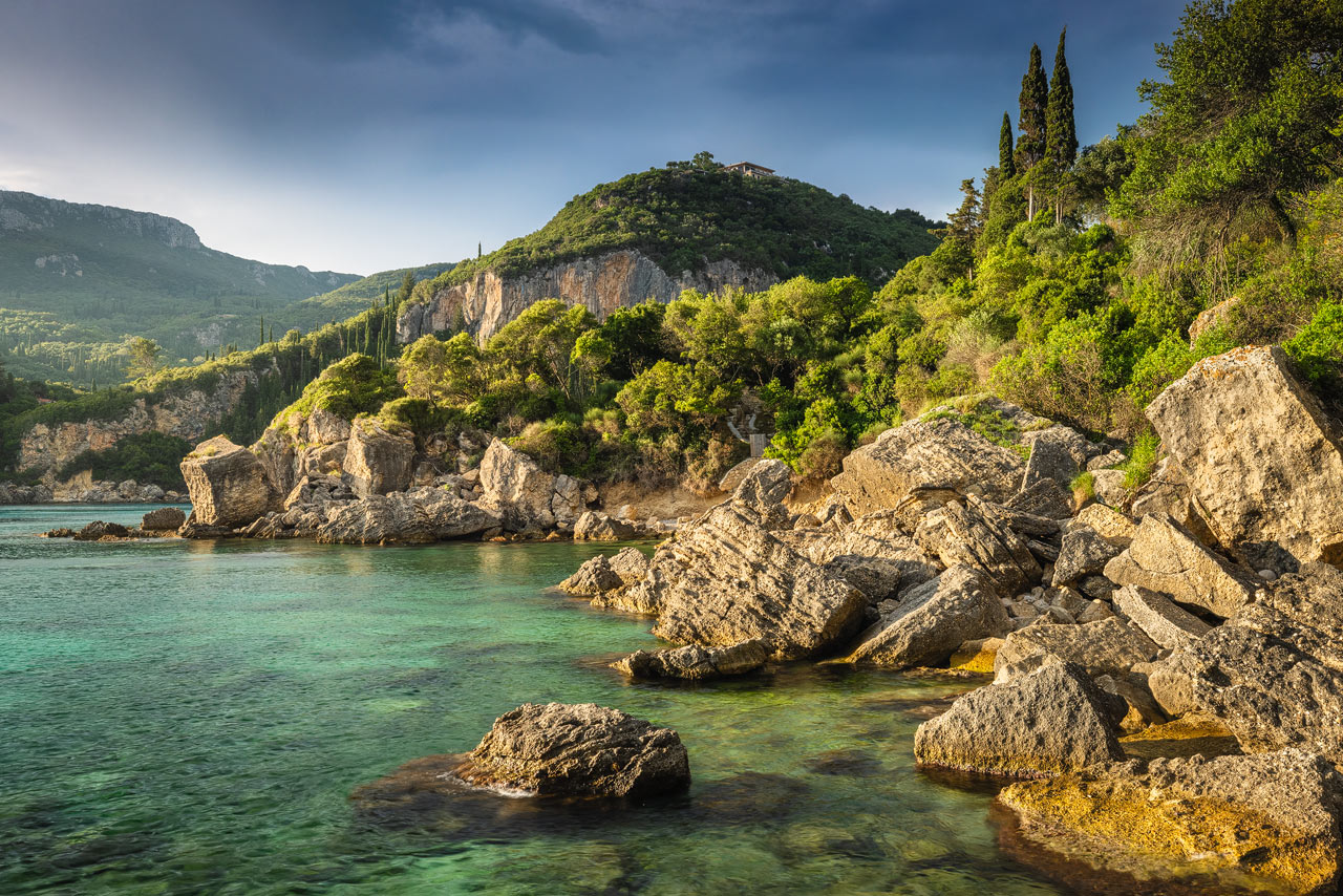 Crystal clear waters against beautiful cliffs and vegetatoin on Corfu 