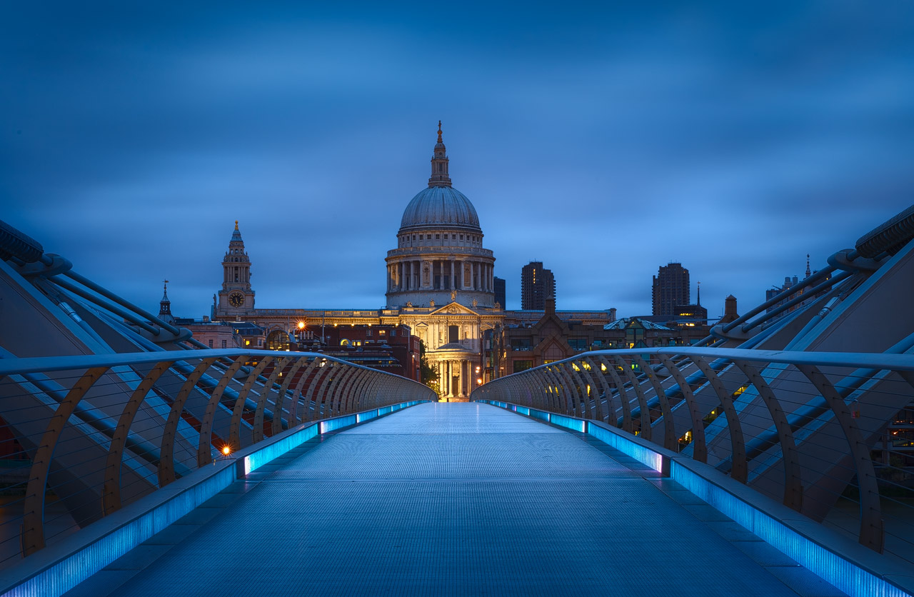 The Millennium Bridge leading towards St. Paul's Cathedral in London during blue hour 