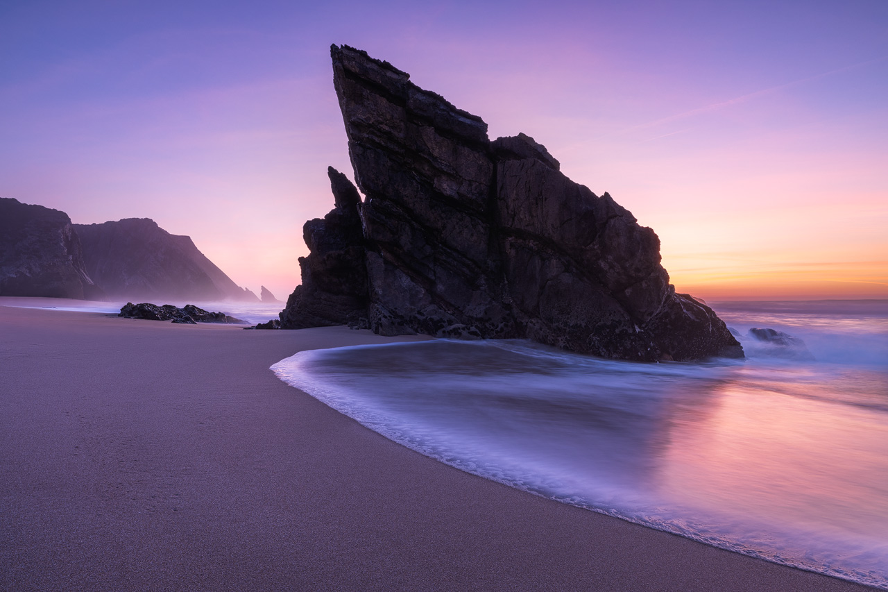 A uniquely shaped sea stack at Praia da Adraga after Sunset