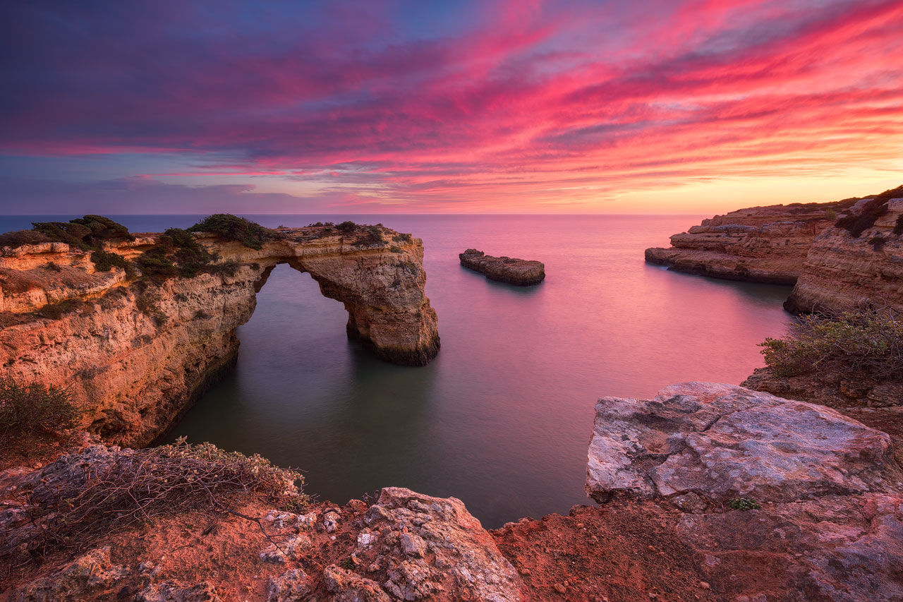 Glowing sky over the cliffs at Praia Albandeira