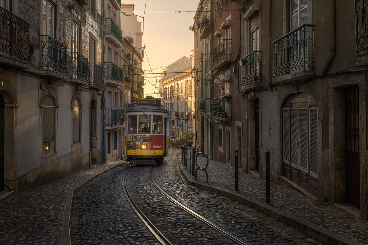 The historic tram in Lisbon angling through a narrow street