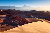 The landscape of Valle de Marte with the Andean Mountians in the distance during sunrise